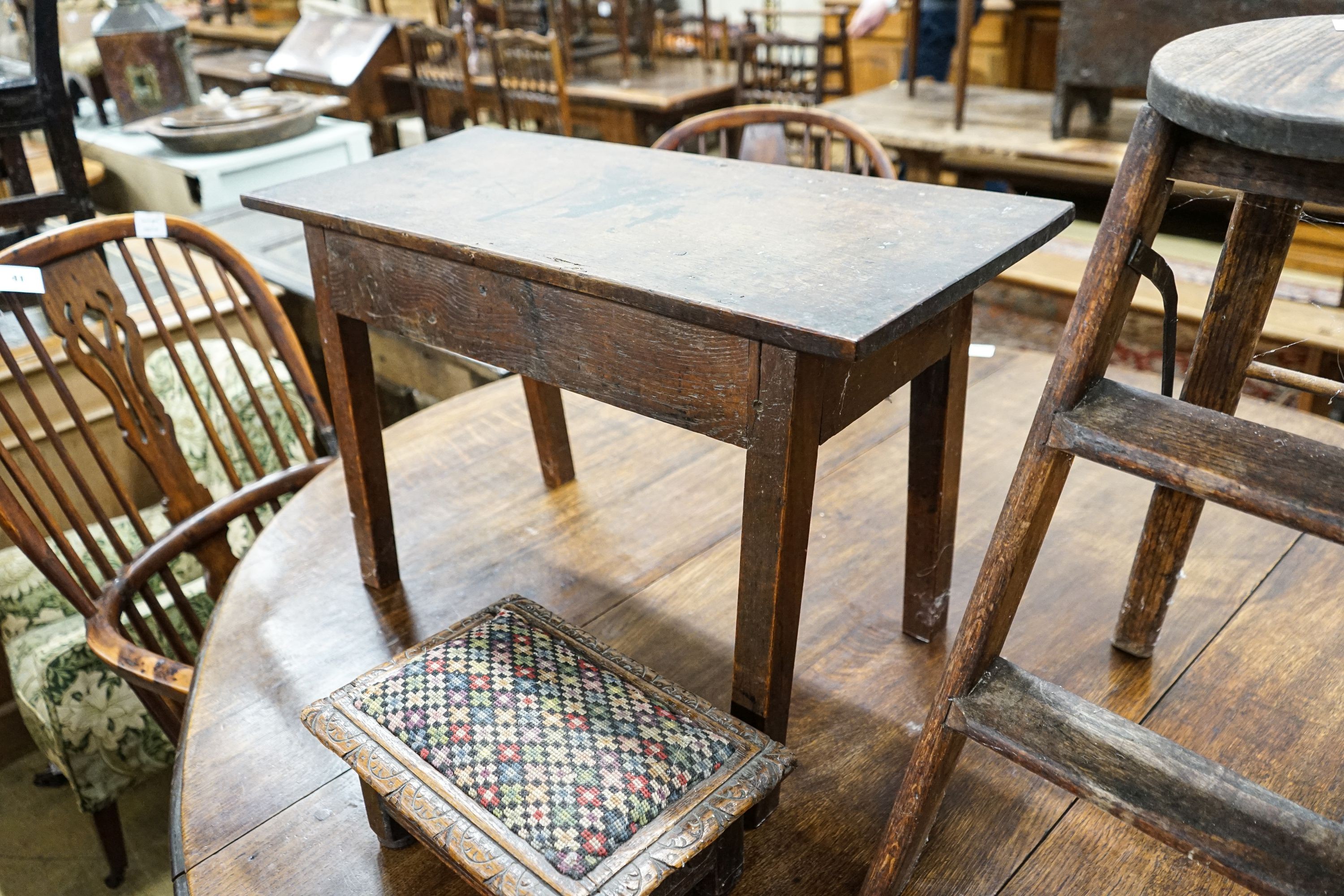 An 18th century oak low table, width 74cm, height 32cm, a carved oak foot stool and an Edwardian oak folding steps stool
